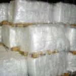 Stacked bales of recycled plastic film on pallets