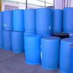 Stacked blue plastic barrels in a storage area