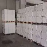 Stacked bales of recycled paper in a warehouse
