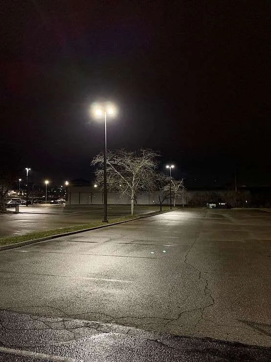 Parking lot at night lit by retrofitted streetlights