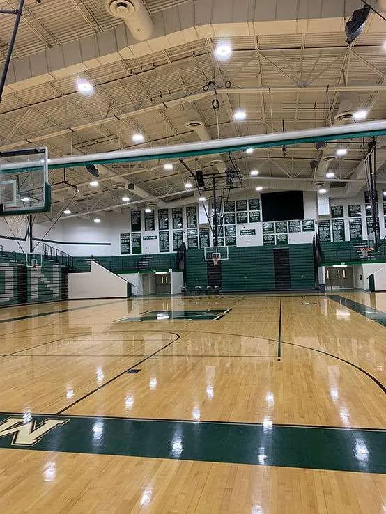 School gym with basketball court under new lighting