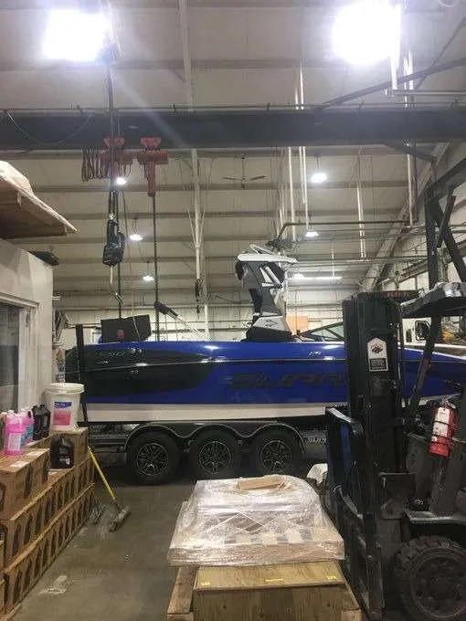 Boat on a trailer inside an industrial workshop