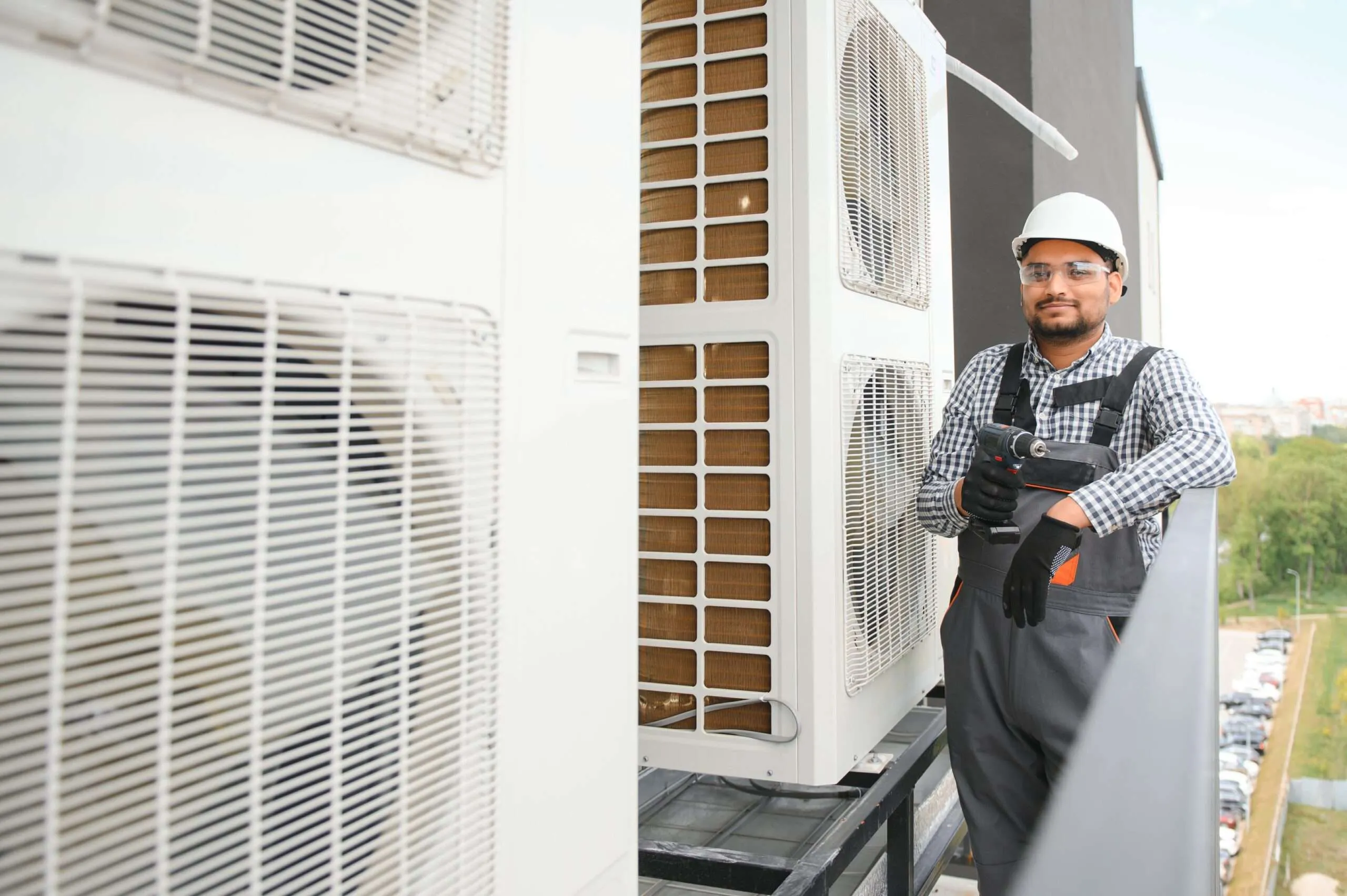 HVAC technician servicing outdoor air conditioning units
