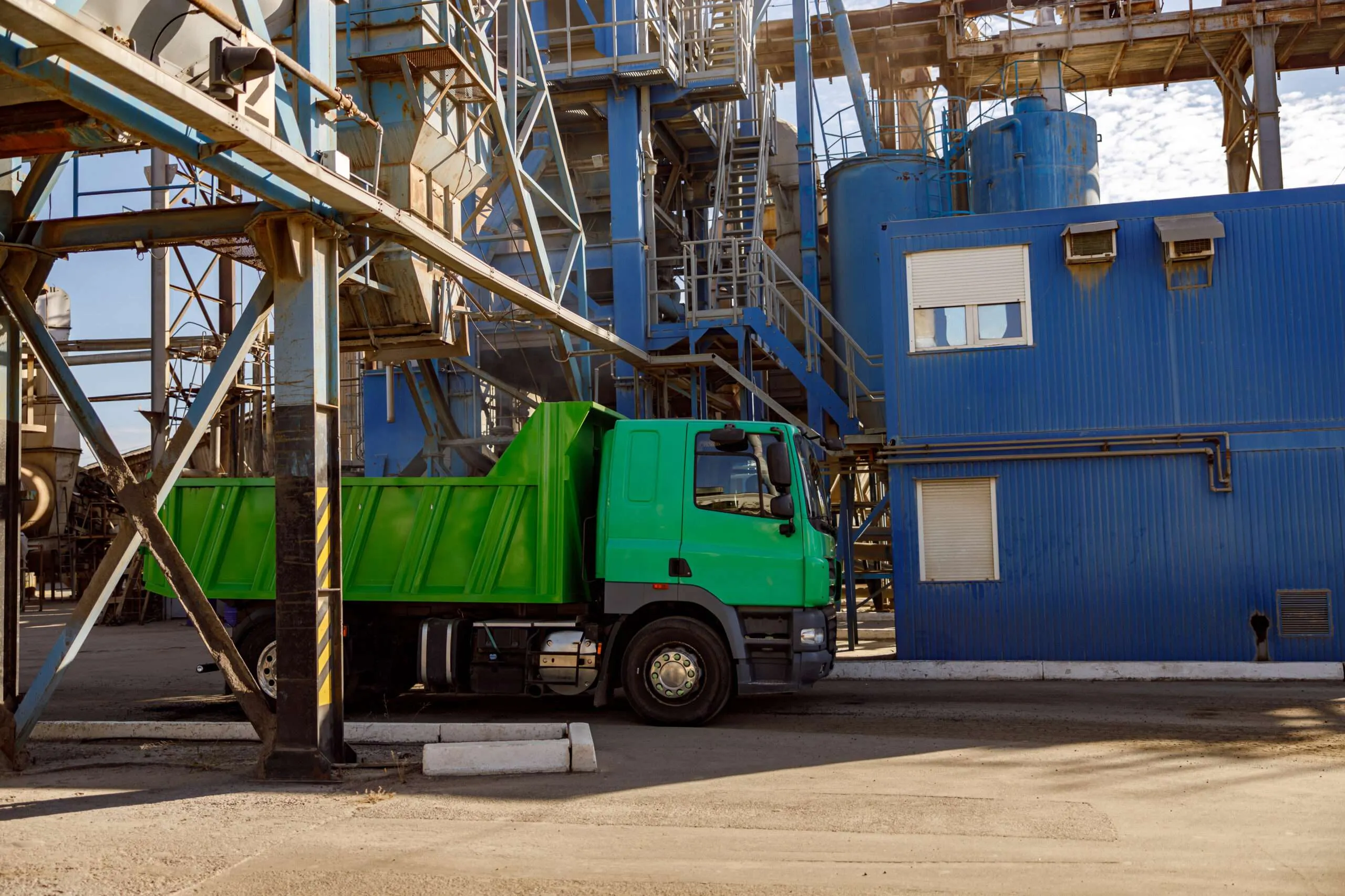 Trucks at an industrial plant loading recovered material for distribution